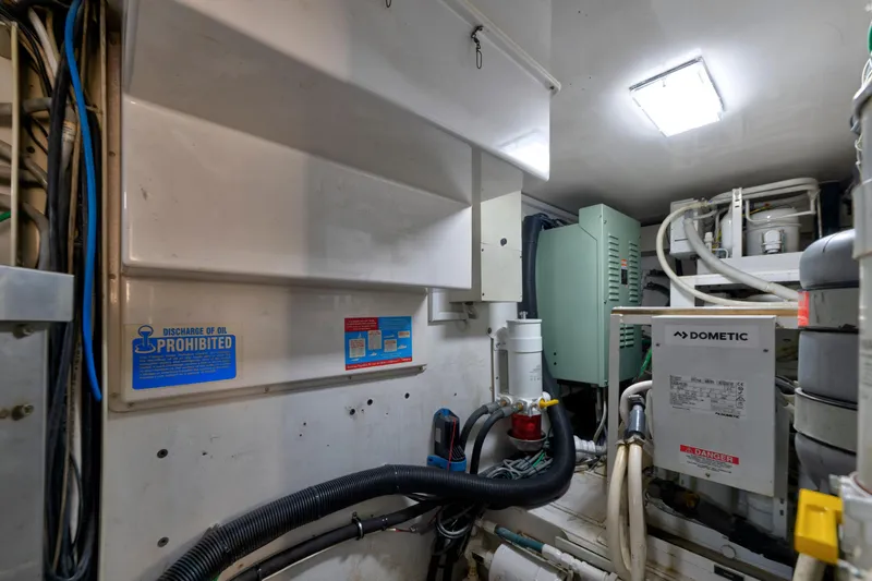  Yacht Photos Pics Engine room of a 2002 Viking Convertible yacht with equipment and warning signs.