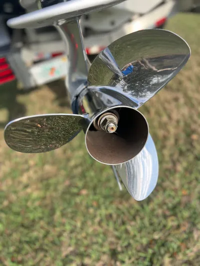  Yacht Photos Pics Close-up of a 2019 Yellowfin 36 Offshore boat propeller, reflecting grass and surroundings.