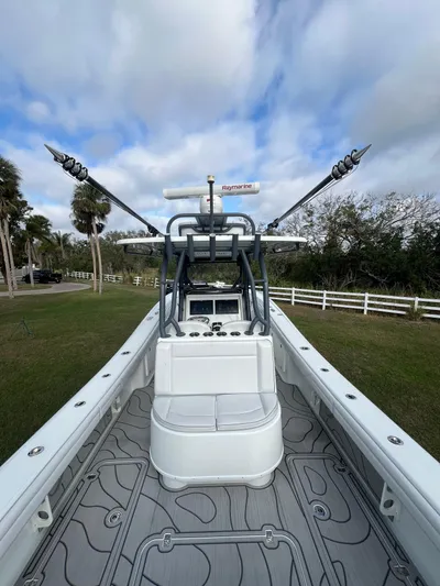  Yacht Photos Pics 2019 Yellowfin 36 Offshore boat with fishing rods, set against a scenic outdoor backdrop.