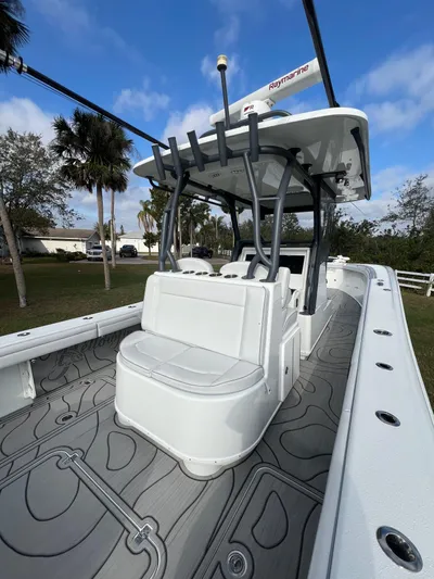  Yacht Photos Pics 2019 Yellowfin 36 Offshore boat with spacious deck and seating, under a clear blue sky.