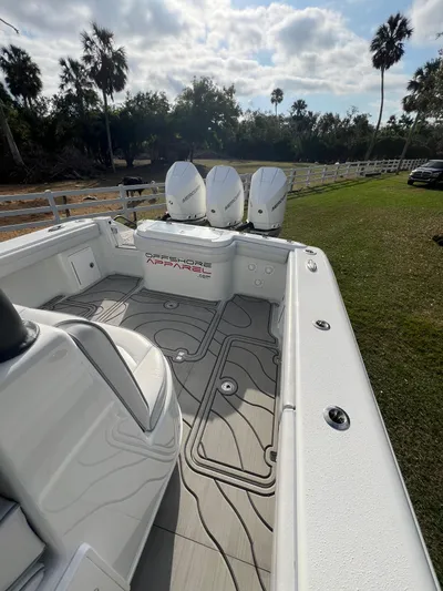  Yacht Photos Pics 2019 Yellowfin 36 Offshore boat with triple engines, sleek deck design, and scenic background.