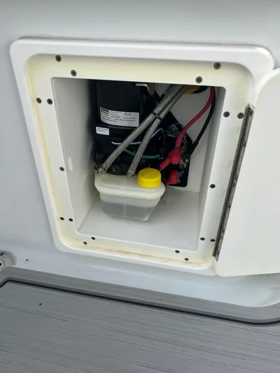  Yacht Photos Pics 2019 Yellowfin 36 Offshore boat compartment with wiring and fluid container.