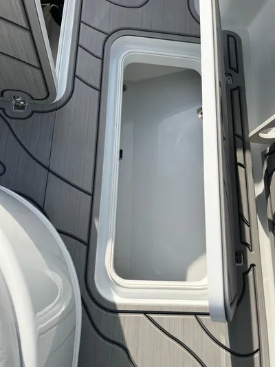  Yacht Photos Pics 2019 Yellowfin 36 Offshore boat storage compartment with open lid, showcasing interior space.