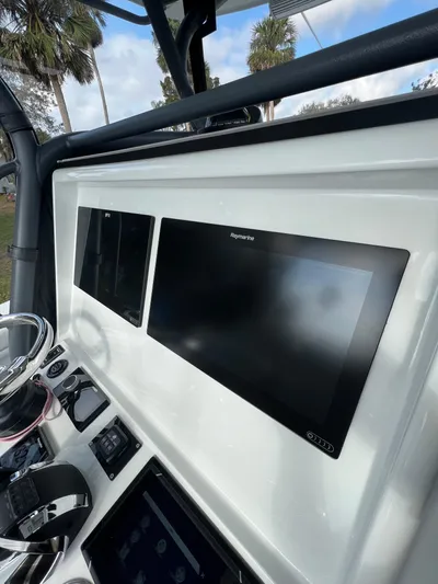  Yacht Photos Pics 2019 Yellowfin 36 Offshore boat dashboard with modern navigation screens.