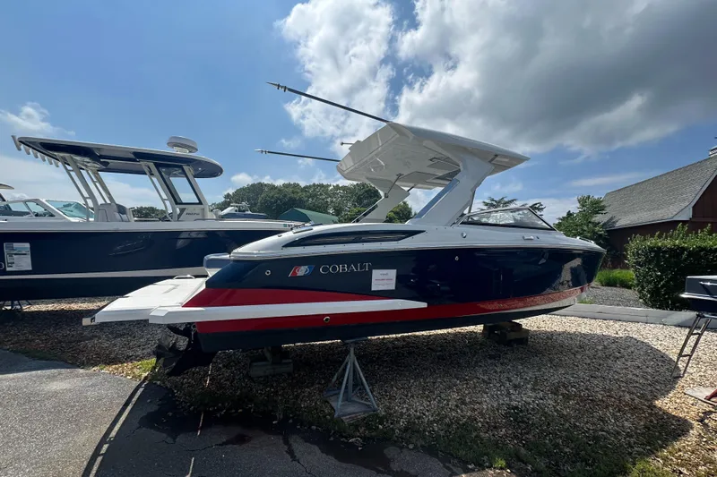  Yacht Photos Pics 2022 Cobalt A29 boat displayed outdoors under a partly cloudy sky.