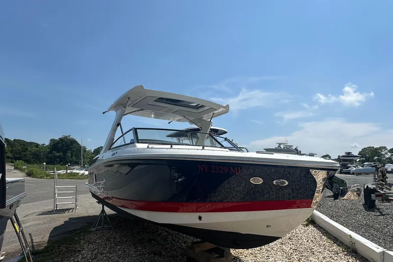  Yacht Photos Pics 2022 Cobalt A29 boat on display under a clear blue sky.