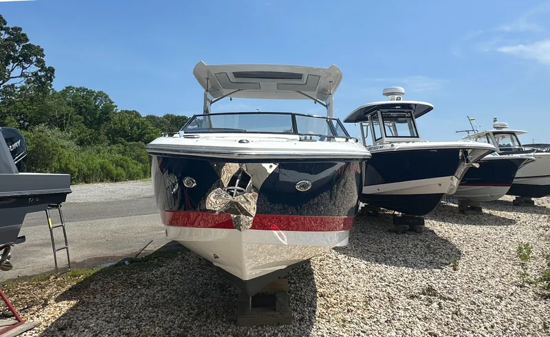  Yacht Photos Pics 2022 Cobalt A29 boat on display, surrounded by other boats, under a clear blue sky.