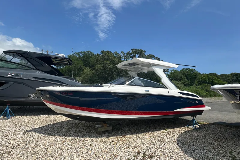  Yacht Photos Pics 2022 Cobalt A29 boat in a marina, blue and white design, sunny day.