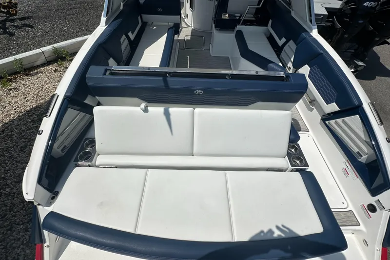  Yacht Photos Pics 2022 Cobalt A29 boat interior with white and blue seating, cup holders, and sleek design.