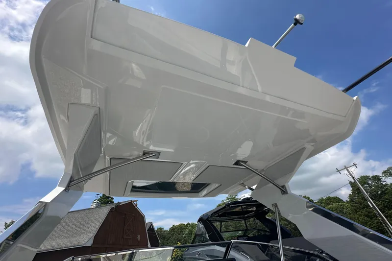  Yacht Photos Pics 2022 Cobalt A29 boat with sleek design and modern features, under a clear blue sky.