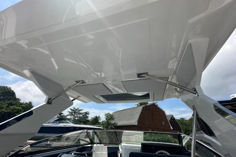  Yacht Photos Pics 2022 Cobalt A29 boat with sleek design and modern canopy structure.