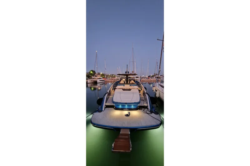 Aegean Infinity Yacht Photos Pics 2023 Solaris Power 44 Open yacht docked at marina during twilight.