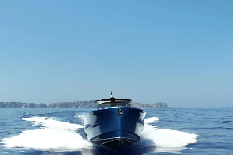 Aegean Infinity Yacht Photos Pics 2023 Solaris Power 44 Open yacht cruising on clear blue ocean waters.