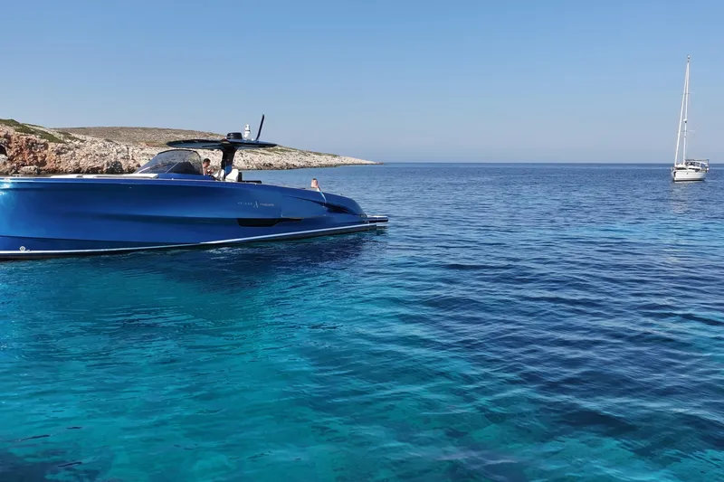 Aegean Infinity Yacht Photos Pics 2023 Solaris Power 44 Open yacht cruising in clear blue waters.