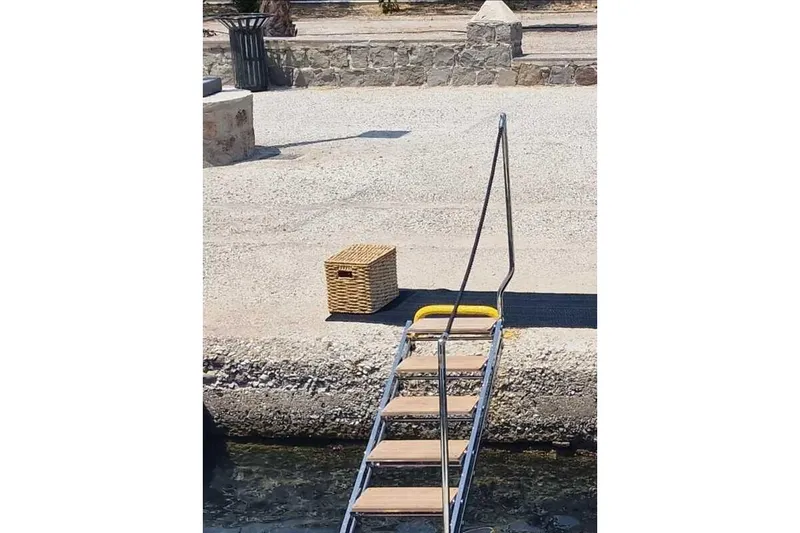 Aegean Infinity Yacht Photos Pics Dockside view with ladder and wicker basket, Solaris Power 44 Open, 2023.