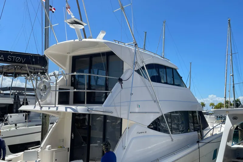  Yacht Photos Pics 2011 Maritimo 56 Cruising Motoryacht docked under clear blue sky.