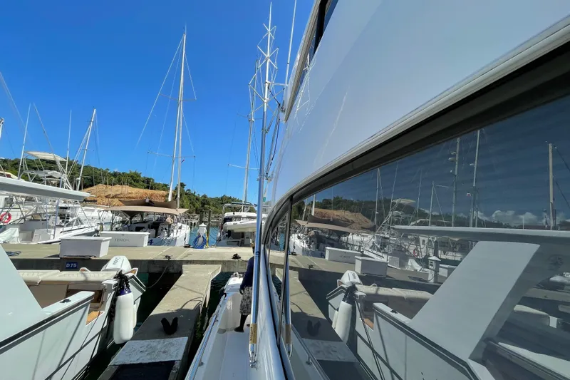  Yacht Photos Pics 2011 Maritimo 56 Cruising Motoryacht docked at marina, reflecting clear blue sky.