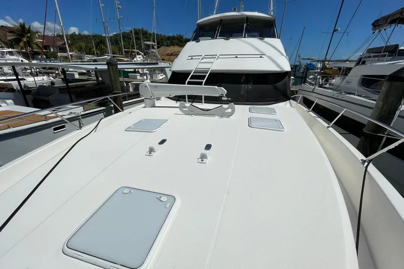  Yacht Photos Pics 2011 Maritimo 56 Cruising Motoryacht docked, showcasing spacious deck and sleek design.