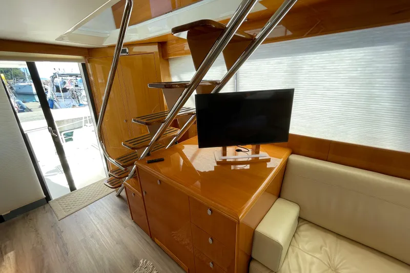  Yacht Photos Pics Interior of 2011 Maritimo 56 Cruising Motoryacht with modern staircase and TV.