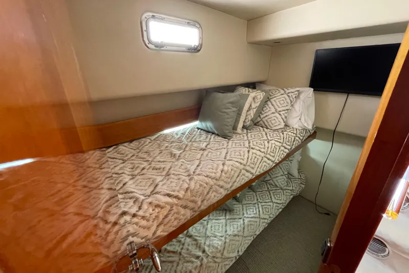  Yacht Photos Pics Cozy cabin interior of 2011 Maritimo 56 Cruising Motoryacht with bunk beds and window.