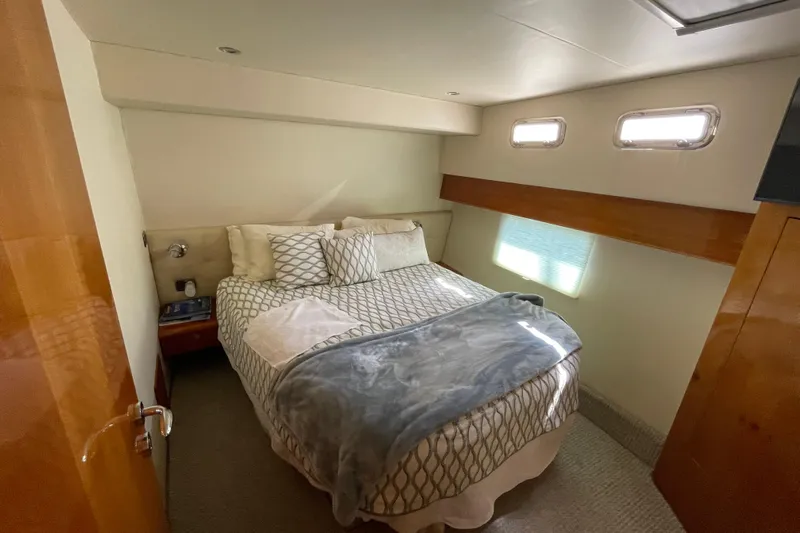  Yacht Photos Pics Cozy bedroom in 2011 Maritimo 56 Cruising Motoryacht with natural light and elegant decor.