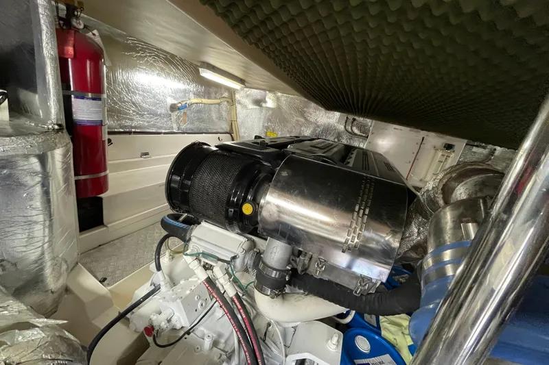  Yacht Photos Pics Engine room of 2011 Maritimo 56 Cruising Motoryacht with visible machinery and fire extinguisher.