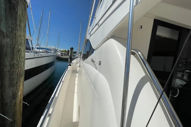 Yacht Photos Pics 2011 Maritimo 56 Cruising Motoryacht docked, showcasing sleek design and polished railings.