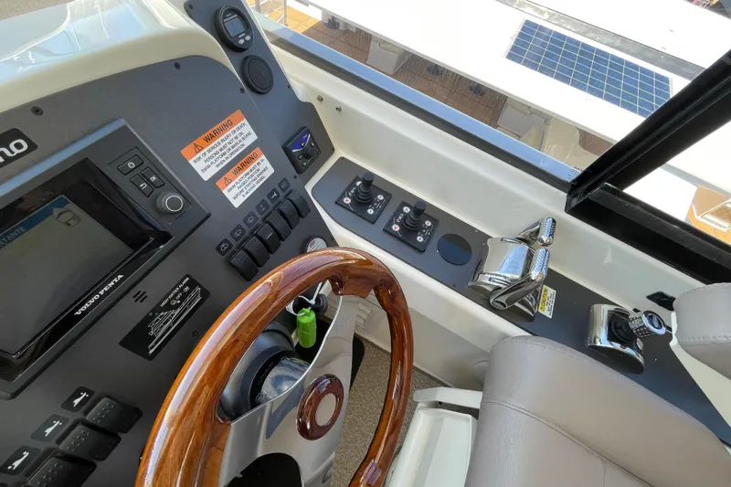 Yacht Photos Pics Helm of 2011 Maritimo 56 Cruising Motoryacht with controls and wooden steering wheel.