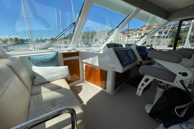  Yacht Photos Pics 2011 Maritimo 56 Cruising Motoryacht interior with helm, seating, and marina view.