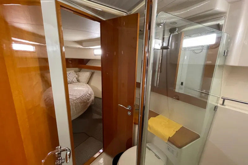  Yacht Photos Pics 2011 Maritimo 56 Cruising Motoryacht interior with bedroom and bathroom view.