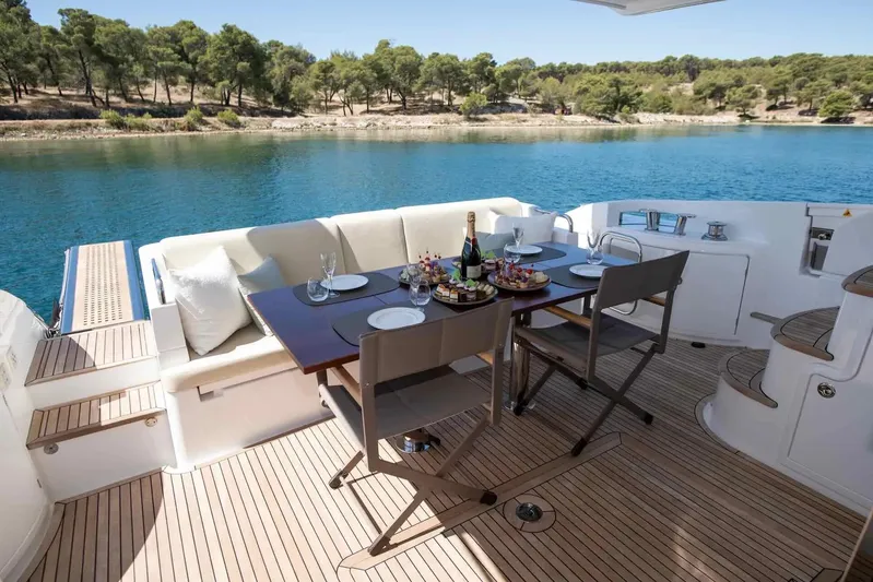 My Laura Yacht Photos Pics Luxurious 2015 Azimut Fly 60 yacht deck with elegant dining setup by serene waters.
