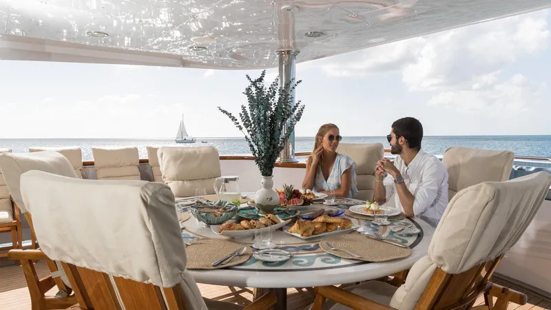 Touch Yacht Photos Pics Couple dining on luxury yacht Louisbourg, 2004, with ocean view and elegant table setting.