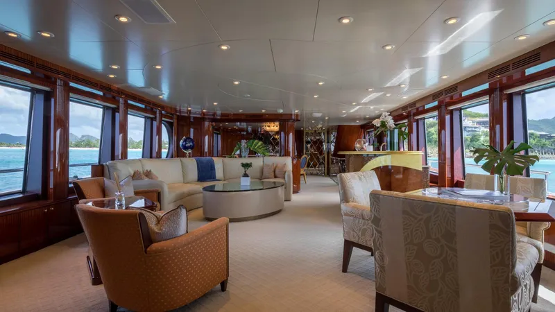 Touch Yacht Photos Pics Luxurious yacht interior with elegant seating, large windows, and scenic ocean views.