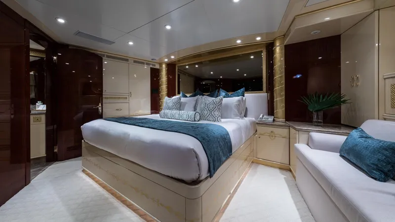 Touch Yacht Photos Pics Luxurious yacht bedroom with elegant decor, featuring a plush bed and ambient lighting, Custom Louisbourg 2004.