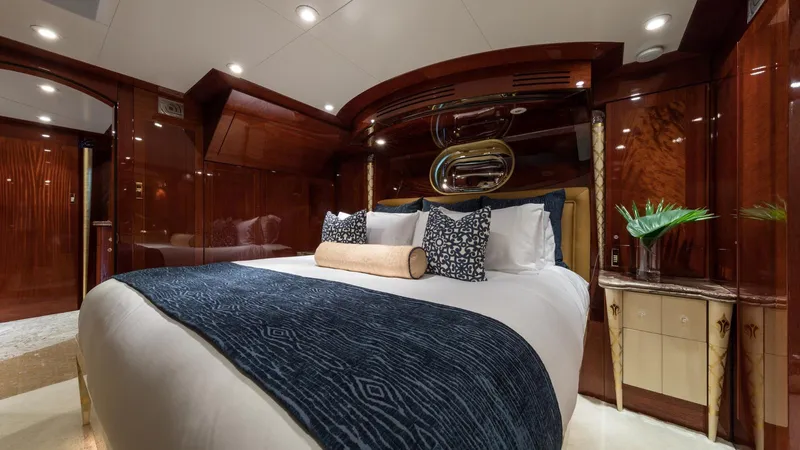 Touch Yacht Photos Pics Luxurious yacht bedroom with elegant wood paneling, plush bedding, and modern decor, Custom Louisbourg 2004.