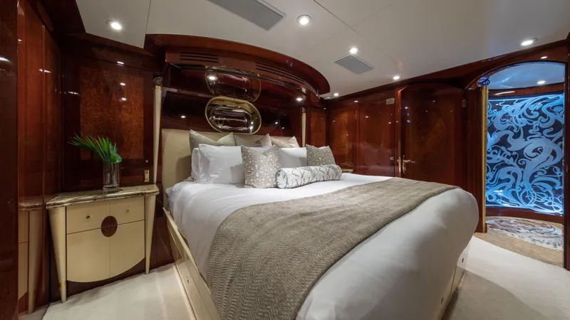 Touch Yacht Photos Pics Luxurious yacht bedroom with elegant wood paneling, plush bedding, and ambient lighting, Custom Louisbourg 2004.