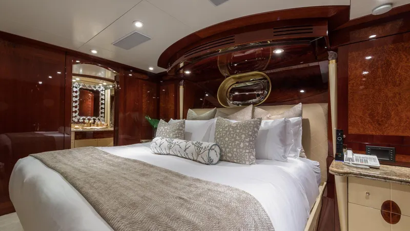 Touch Yacht Photos Pics Luxurious yacht bedroom with elegant wood paneling, plush bedding, and ambient lighting, Custom Louisbourg 2004.