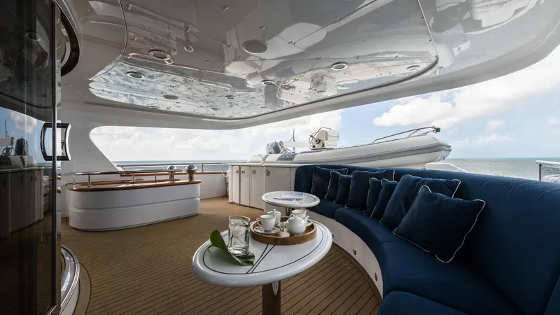 Touch Yacht Photos Pics Luxurious yacht deck with blue seating, tableware, and ocean view; Custom Louisbourg 2004 model.