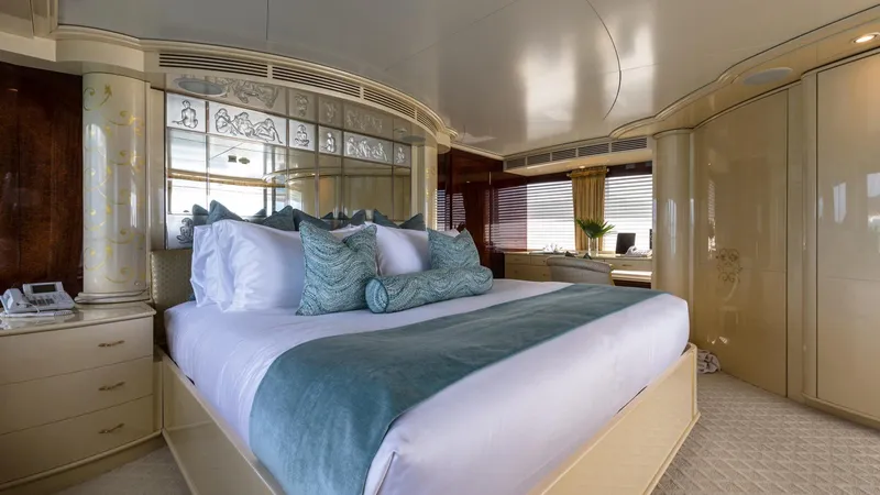Touch Yacht Photos Pics Luxurious yacht bedroom with elegant decor, featuring a large bed and stylish furnishings, 2004 Custom Louisbourg.
