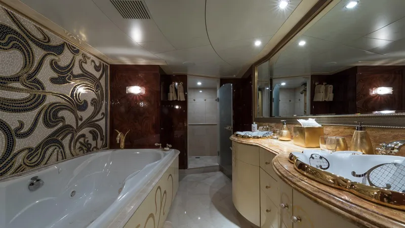 Touch Yacht Photos Pics Luxurious bathroom with ornate mosaic wall, elegant bathtub, and stylish vanity in a 2004 Custom Louisbourg.