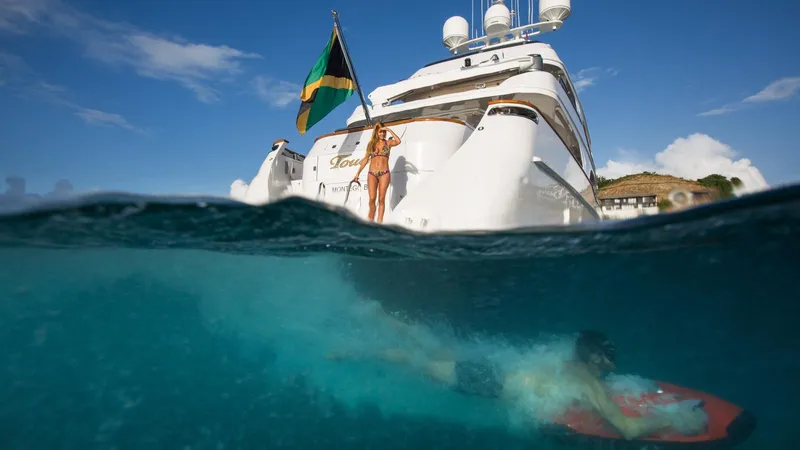 Touch Yacht Photos Pics Luxury yacht Louisbourg with swimmer underwater, clear blue sea, sunny day.