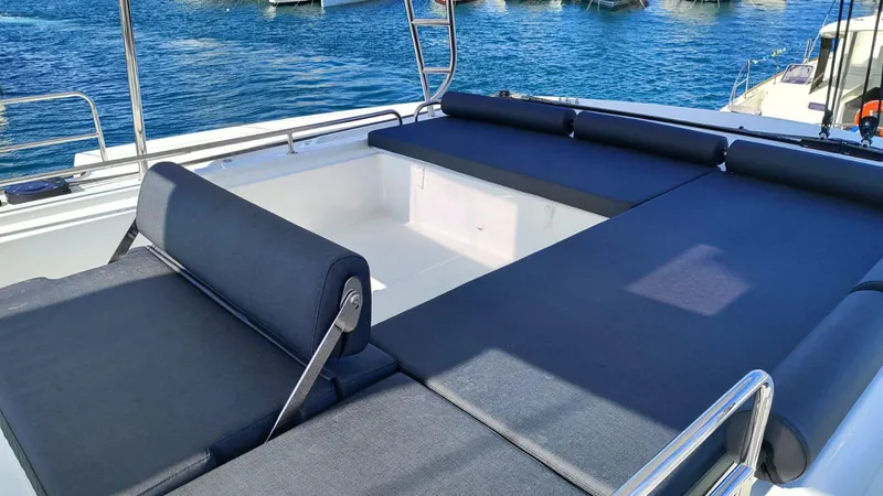  Yacht Photos Pics 2024 Lagoon 51 yacht with spacious sunbathing area and sleek design on the water.