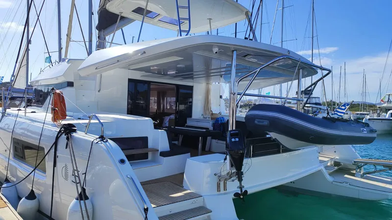  Yacht Photos Pics 2024 Lagoon 51 yacht docked, featuring spacious deck and modern design.
