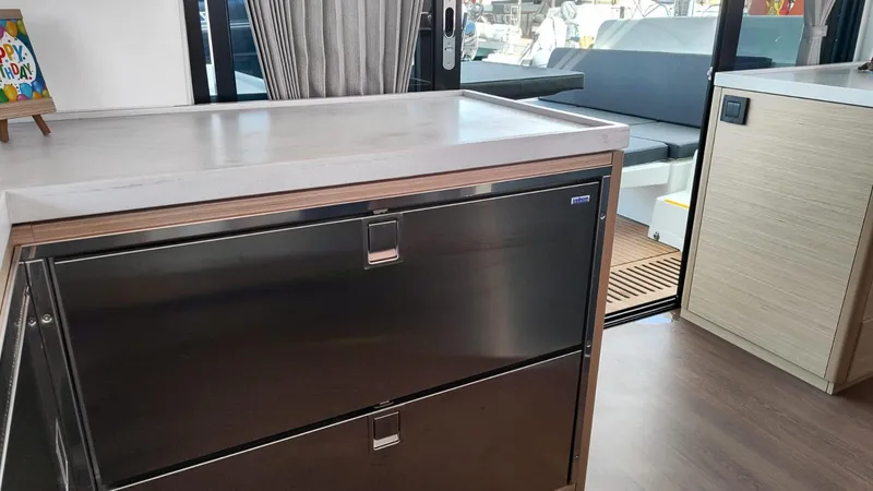  Yacht Photos Pics Interior of 2024 Lagoon 51 yacht featuring modern kitchen and seating area.