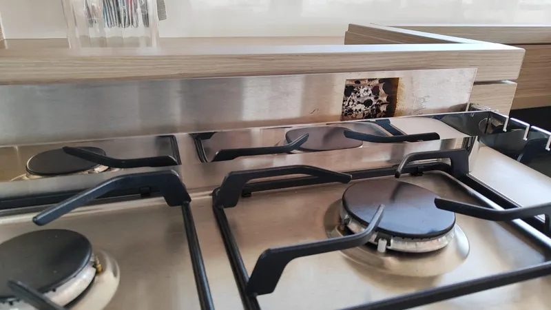  Yacht Photos Pics Modern kitchen stove in 2024 Lagoon 51 yacht, featuring sleek stainless steel burners.