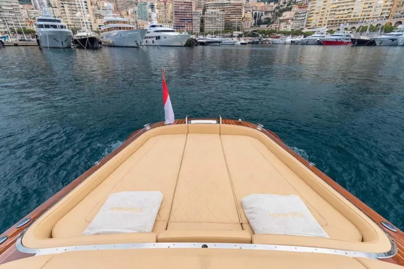 Visionnaire Yacht Photos Pics Luxurious J Craft Torpedo 42 yacht, 2010, docked in a scenic marina with cityscape backdrop.