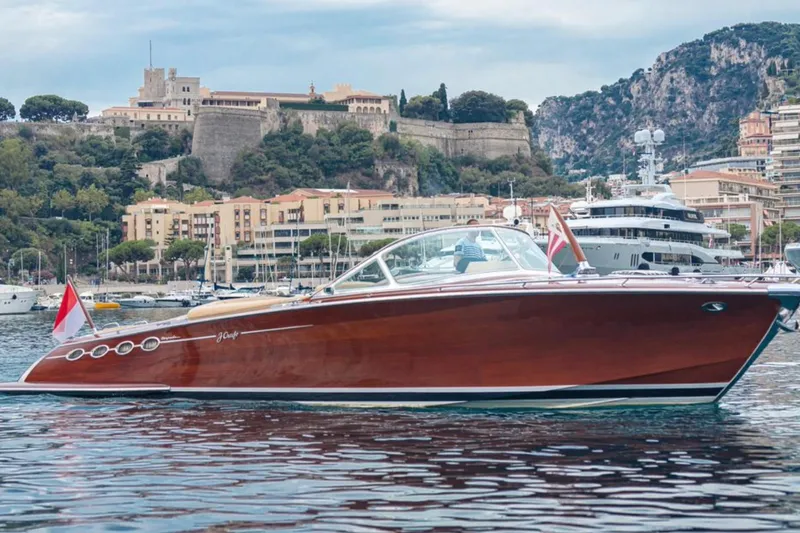 Visionnaire Yacht Photos Pics Luxurious 2010 J Craft Torpedo 42 yacht cruising in scenic harbor setting.