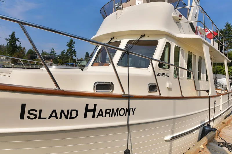 Island Harmony Yacht Photos Pics 2012 North Pacific NP 38 Sedan boat named "Island Harmony" docked with Canadian flag.