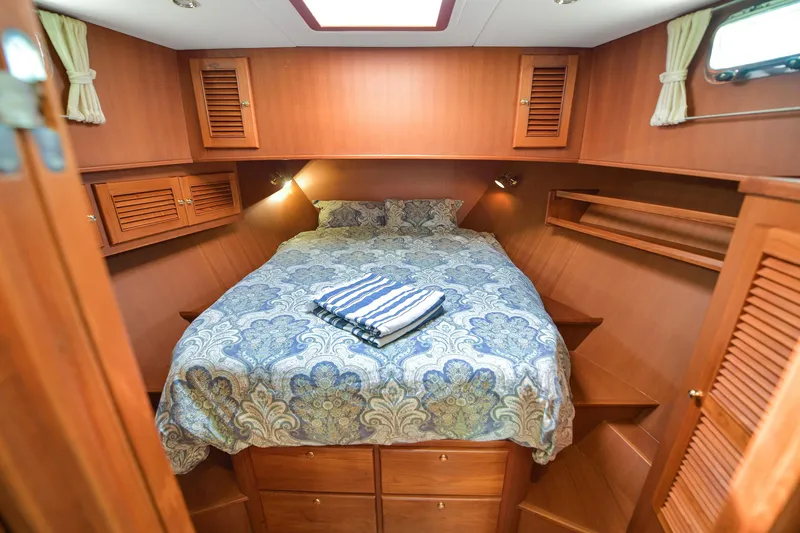 Island Harmony Yacht Photos Pics Cozy cabin interior of 2012 North Pacific NP 38 Sedan with wood paneling and bed.