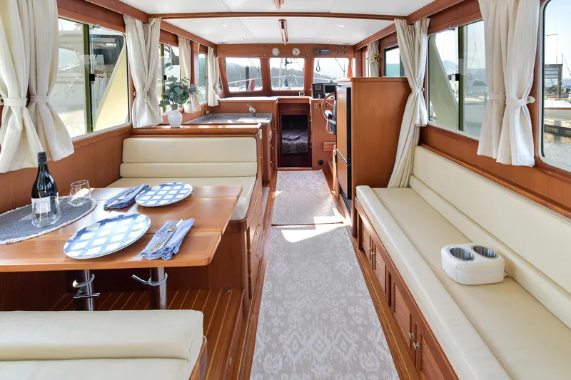 Island Harmony Yacht Photos Pics Luxurious interior of 2012 North Pacific NP 38 Sedan yacht with elegant dining area.